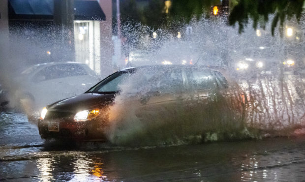 wettest july car splashes through standing water...