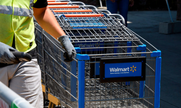 An employee gathers shopping carts at Walmart, July 22, 2020 in Burbank, California. - The country'...