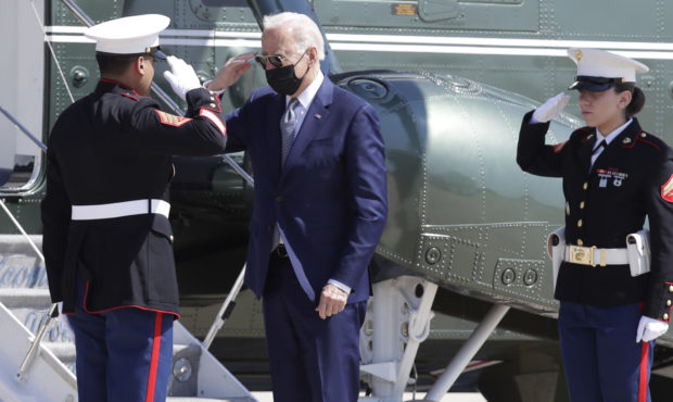 President Joe Biden returns a salute with a Marine Corp honor guard as he disembarks Marine One bef...