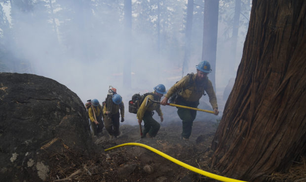 Members of a hotshot crew hike up the mountain while battling the Caldor Fire in South Lake Tahoe, ...