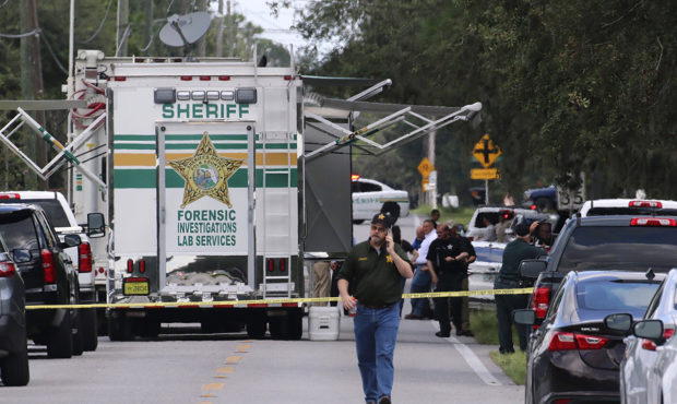 Polk County, Fla., Sheriff's officials work the scene of a multiple fatality shooting Sunday, Sept....