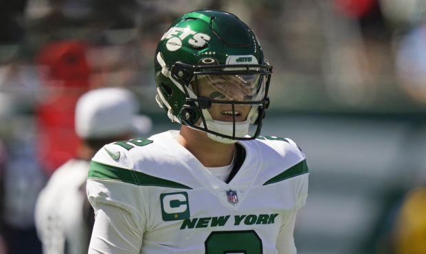 New York Jets quarterback Zach Wilson reacts after throwing an interception during the first half o...