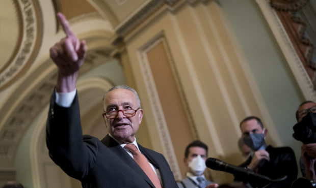Senate Majority Leader Chuck Schumer, D-N.Y., takes questions as he speaks to reporters after a wee...