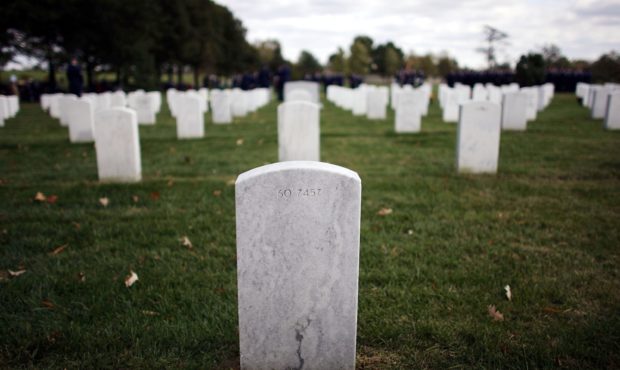 FILE -- ARLINGTON, VA - OCTOBER 24:  A headstone stands as family and freinds gather for burial ser...