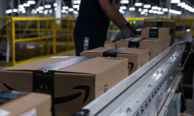 Boxes move along a conveyor belt at an Amazon fulfillment center on Prime Day in Raleigh, North Car...