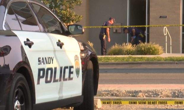 (Crews outside of the Arcadia apartments in Sandy after the officer-involved shooting.  Photo: Dere...
