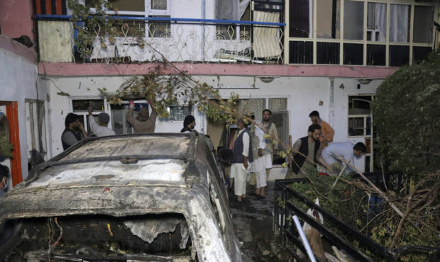 FILE - In this Sunday, Aug. 29, 2021 file photo, Afghans inspect damage of Ahmadi family house afte...