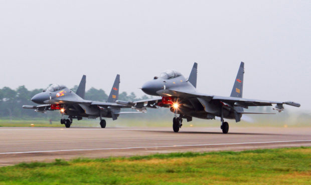 FILE - In this undated file photo released by China's Xinhua News Agency, two Chinese SU-30 fighter...