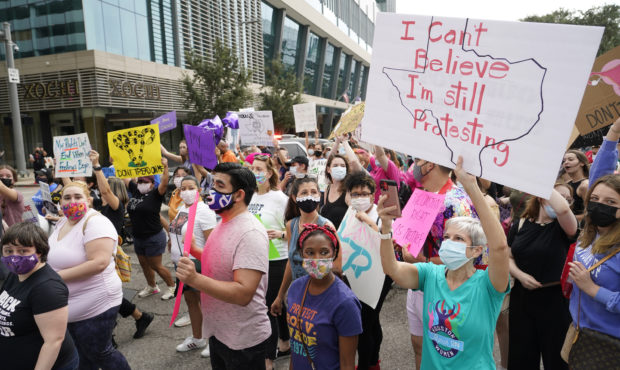 FILE - In this Oct. 2, 2021 file photo people participate in the Houston Women's March against Texa...