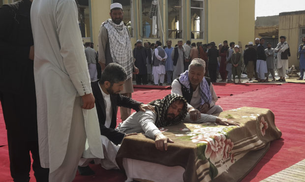 Relatives and residents attend a funeral ceremony for victims of a suicide attack at the Gozar-e-Sa...