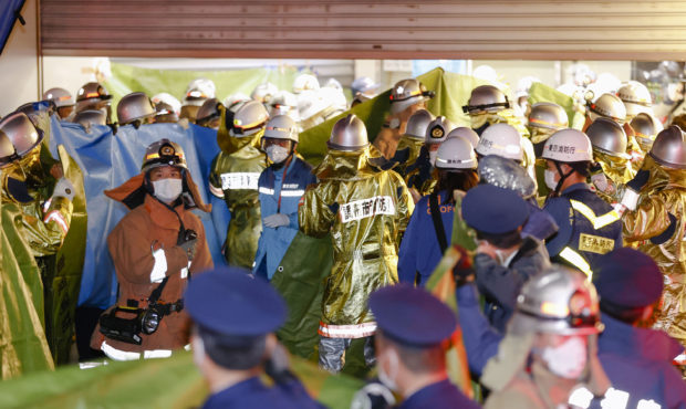 Emergency workers and police officers at a train station in Tokyo, Sunday Oct. 31, 2021 after a man...