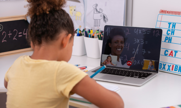 Photo of a young student learning from their teacher via the computer. Photo: Canva...