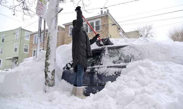 GUTTENBERG, NEW JERSEY - FEBRUARY 02: A woman shovels her car out of the snow on February 02, 2021 ...