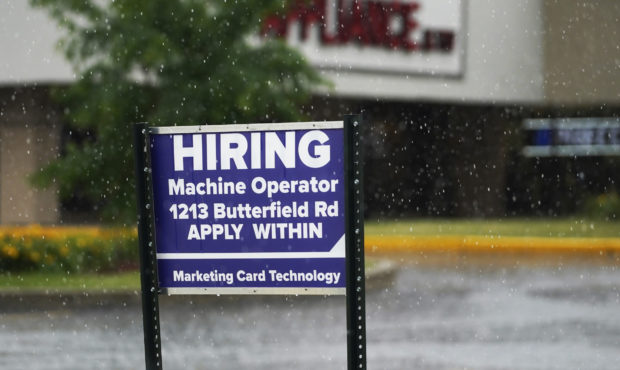 FILE - A hiring sign is displayed in Downers Grove, Ill., on June 24, 2021.  The number of American...