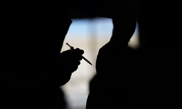 FILE - A man receives a COVID-19 vaccine at a vaccination site in Las Vegas. About 4 million federa...