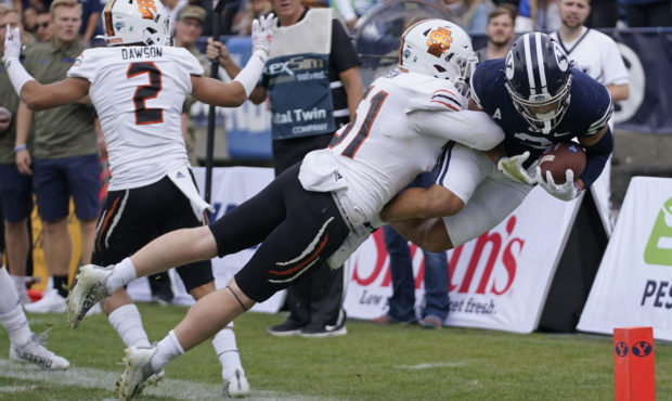 Idaho State linebacker Jared Gibson (51) knocks BYU wide receiver Neil Pau'u, right, out of bounds ...