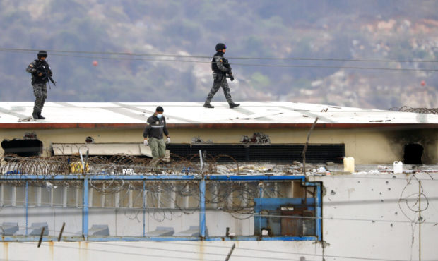 The body of a prisoner appears surrounded by police on the roof of the Litoral penitentiary the mor...