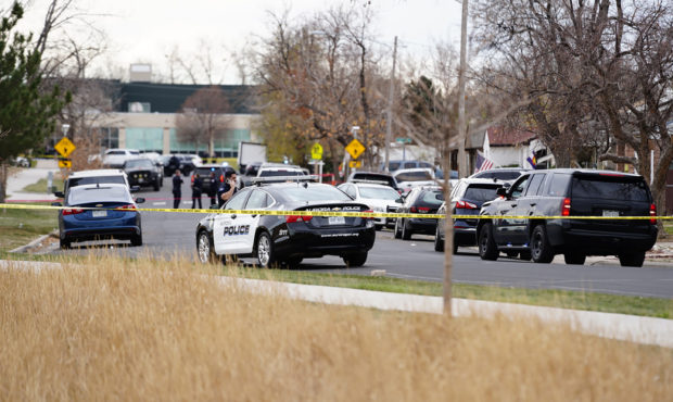 Law enforcement officials survey the scene of a shooting in which six teenagers were injured in a p...