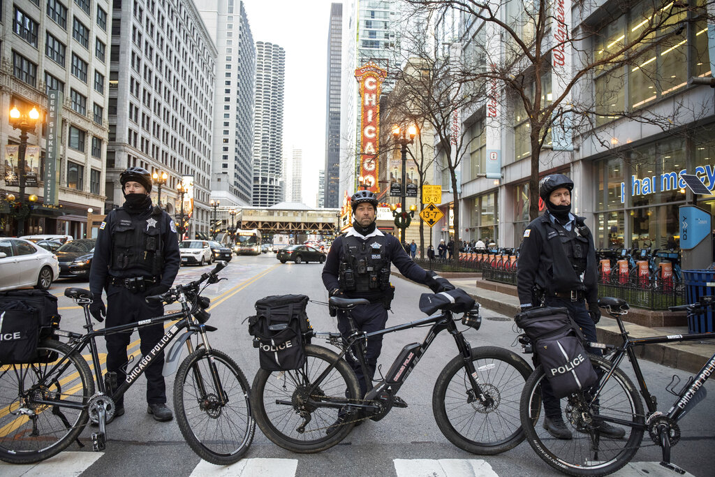 Police form a barricade along North State Street in the Loop during as people march to protest the ...