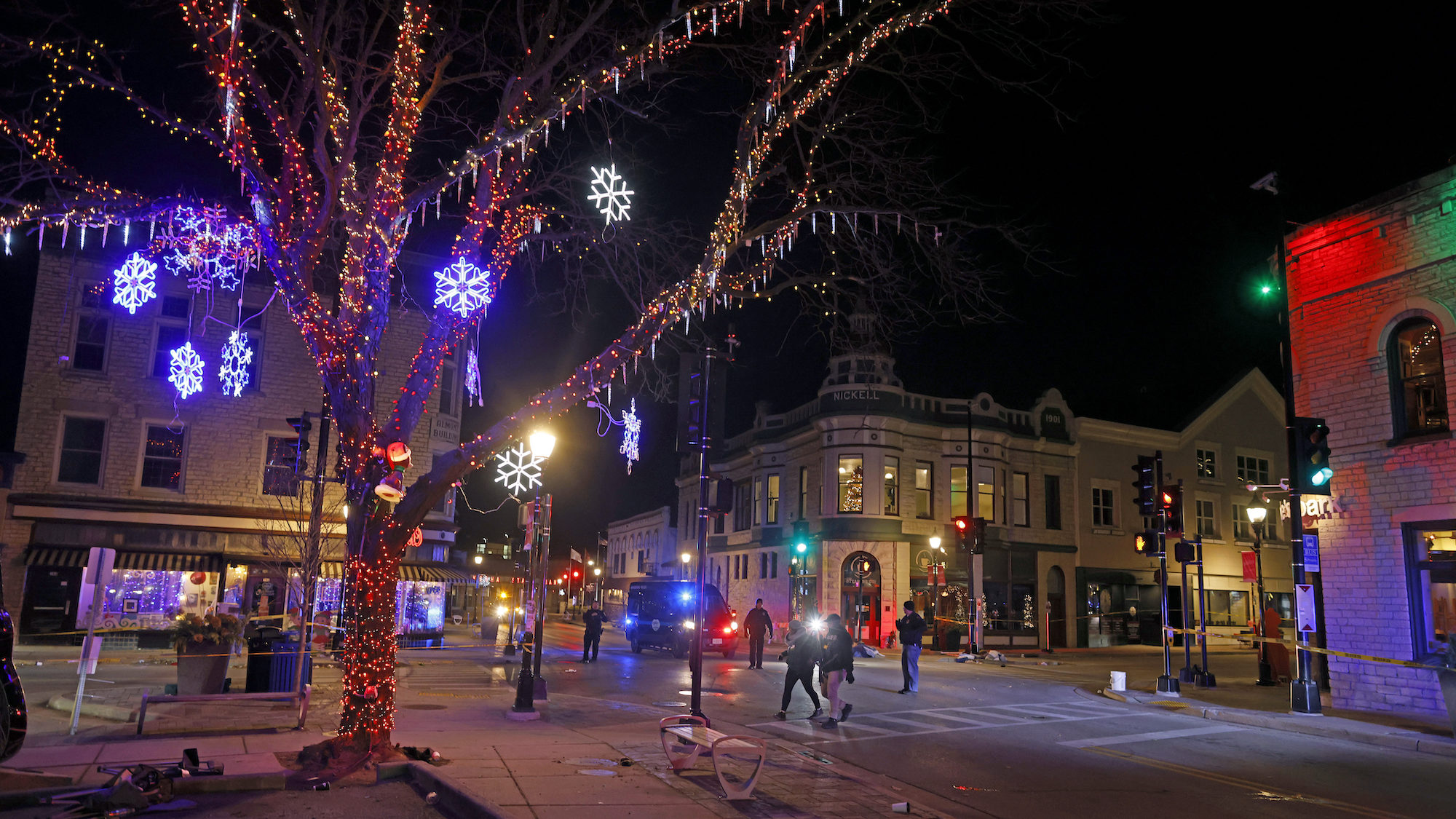 Police in Waukesha, Wi., canvass the downtown streets after vehicle plowed into a Christmas parade ...