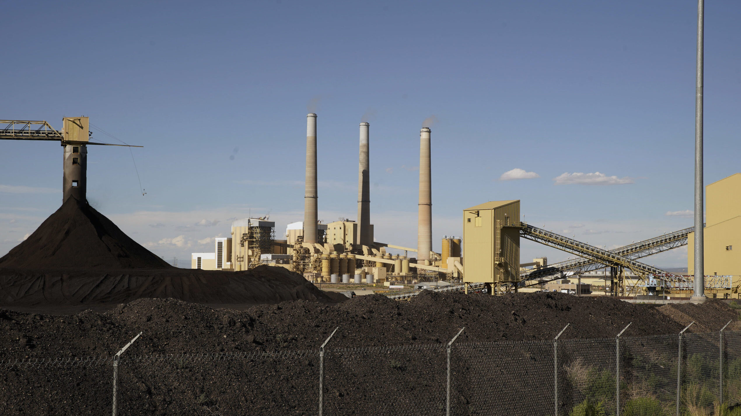 Large coal piles sit in front of PacifiCorps, Hunter, 1,320 megawatt coal fired power plant on June...