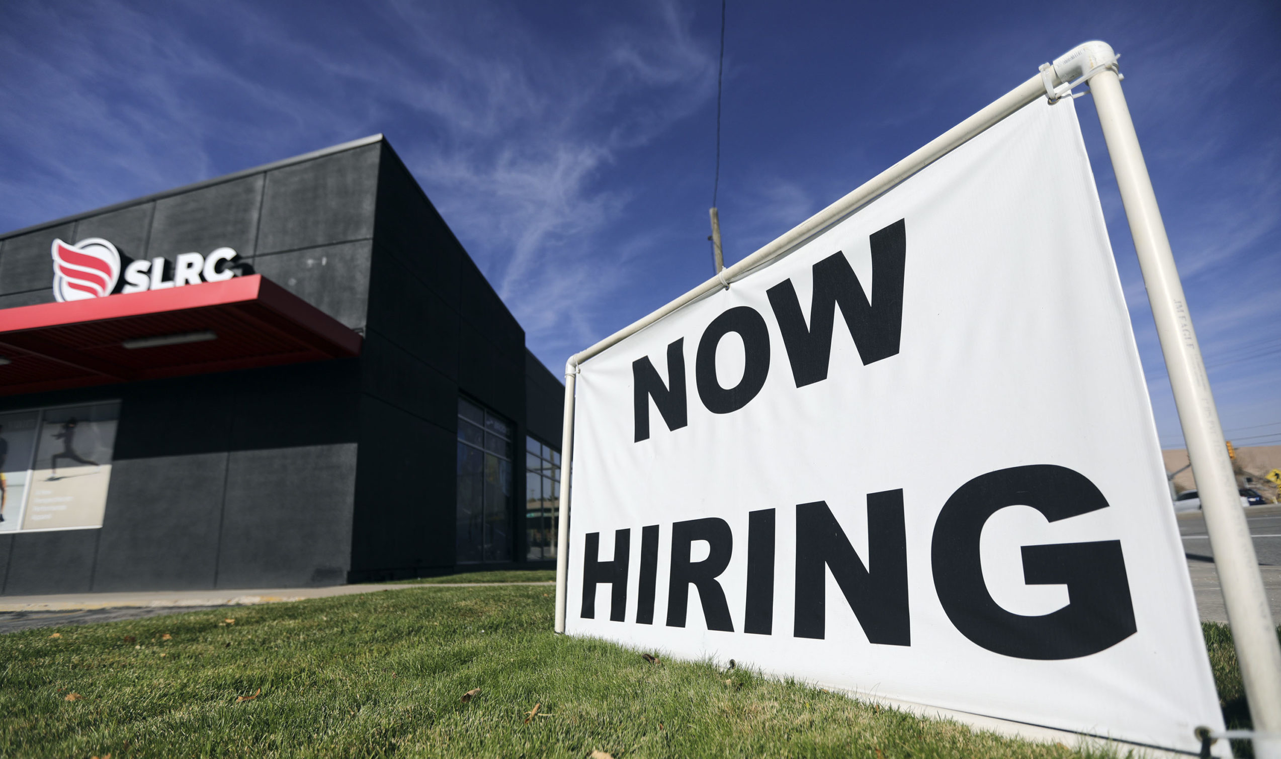A “now hiring” sign is pictured at Salt Lake Running Company in Salt Lake City on Friday, Nov. ...