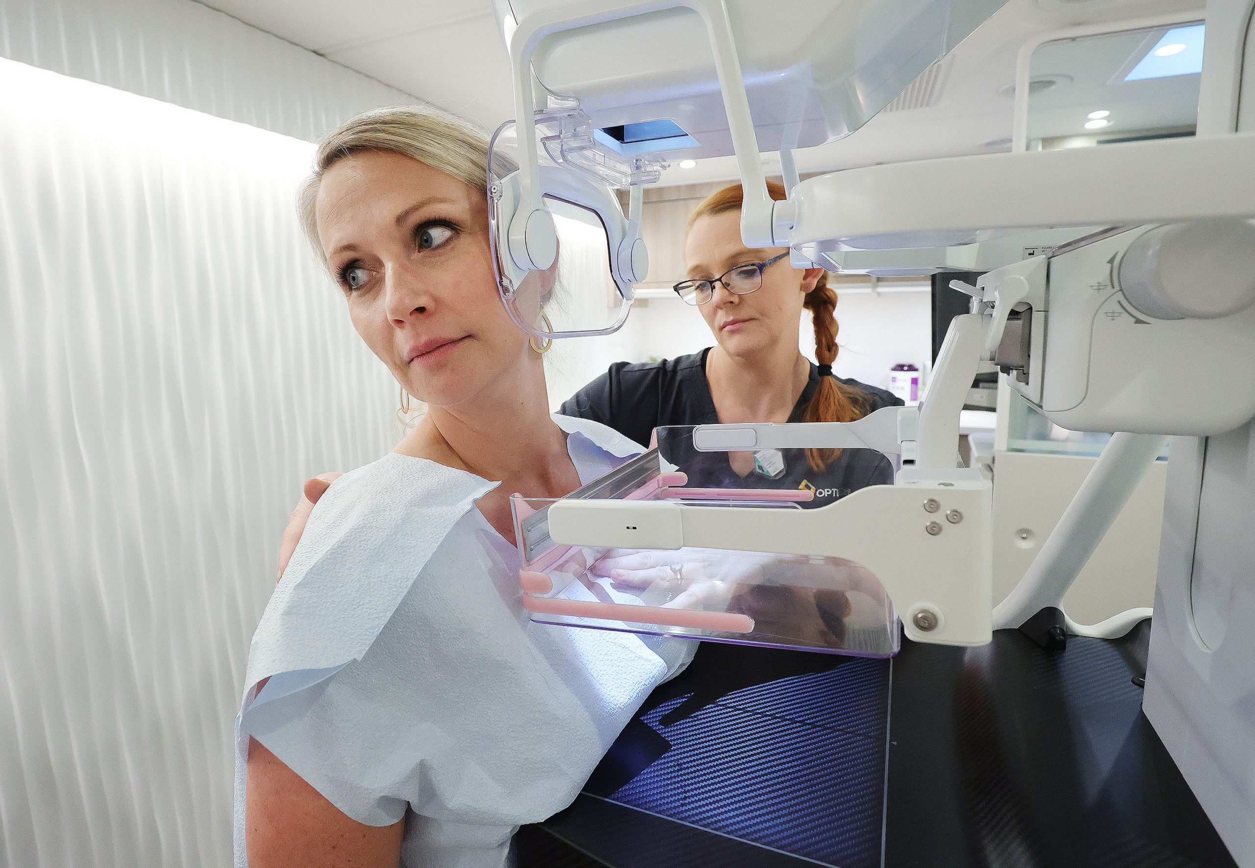 Mammogram technician Niki Keene, right,  demonstrates a mammogram on Kathy Dalton as Optum Care Net...