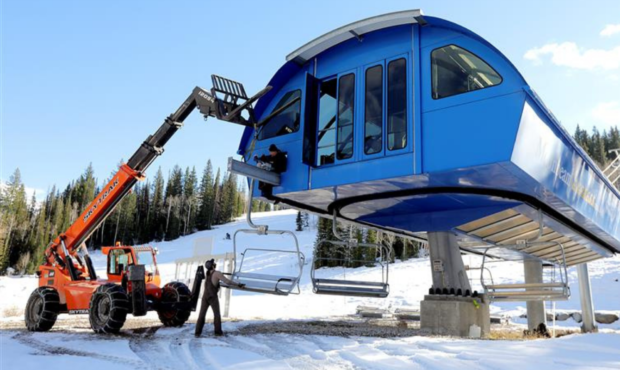 Cody Reed and Pekka Vanninen load chairs onto the Moonbeam Express chairlift in preparation for the...