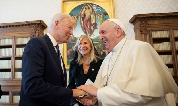 US President Joe Biden, left, shakes hands with Pope Francis as they meet at the Vatican, Friday, O...