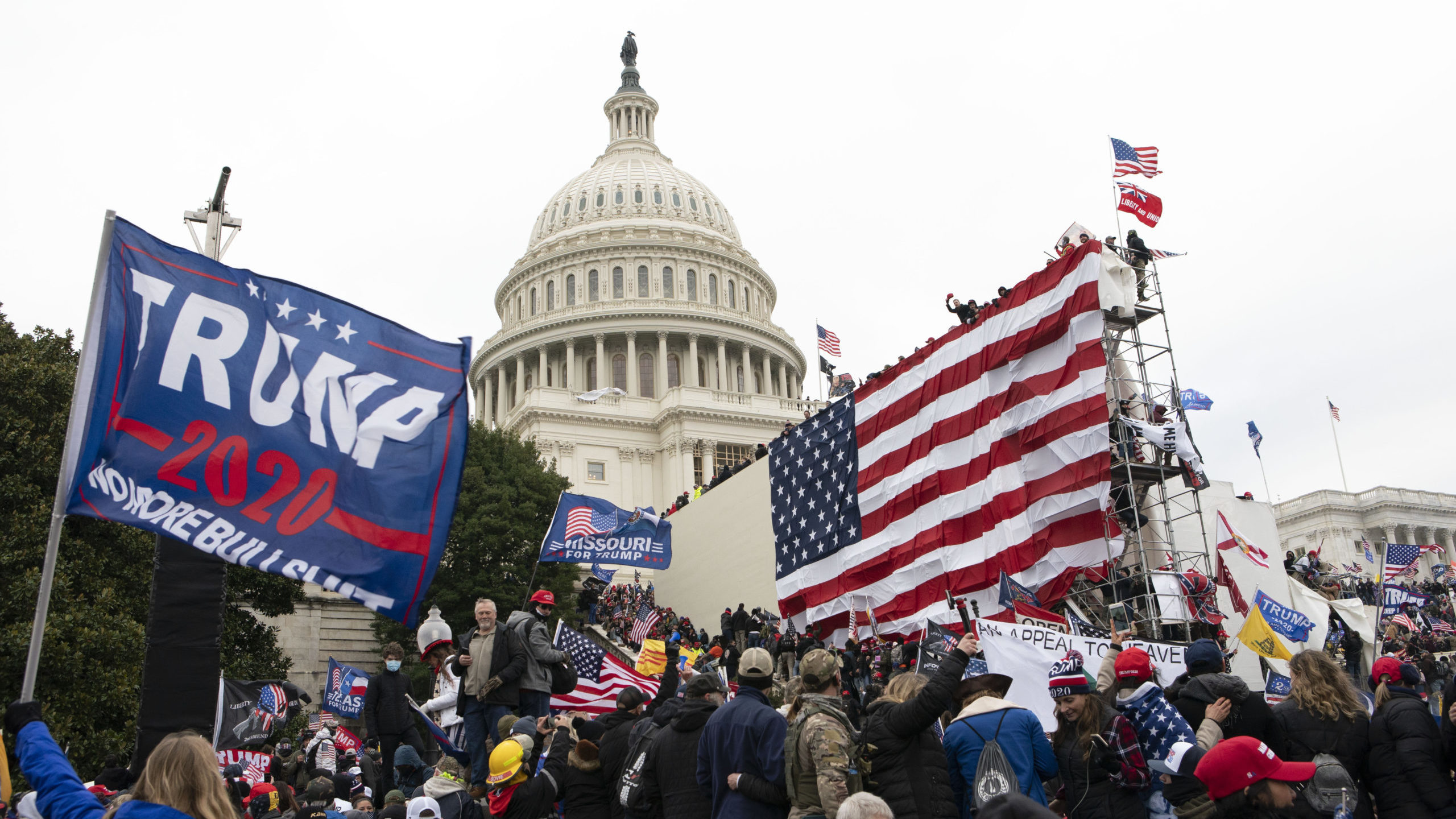 FILE - Violent insurrectionists loyal to President Donald Trump stand outside the U.S. Capitol in W...
