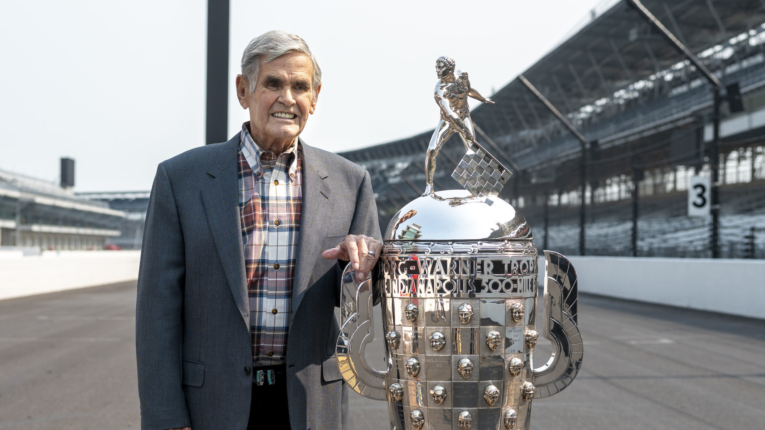 FILE - Four-time winner of the Indianapolis 500, Al Unser, poses with the Borg-Warner Trophy at the...