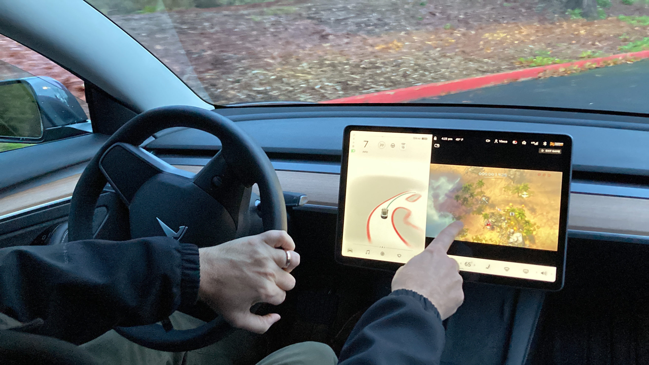 FILE - Vince Patton, a new Tesla owner, demonstrates on Dec. 8, 2021, on a closed course in Portlan...