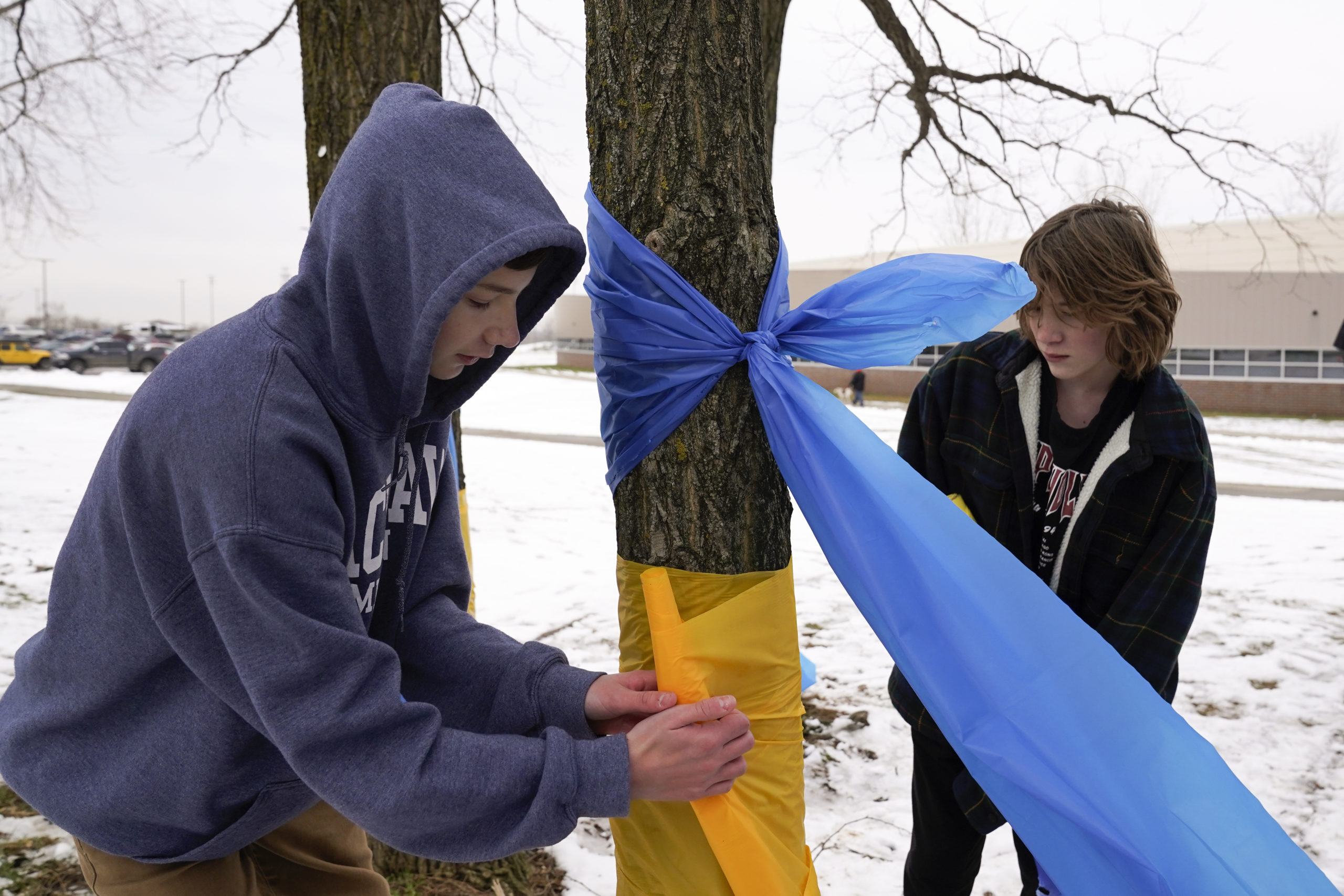 students respond to traumatic event after school shooting by tying ribbons around trees...