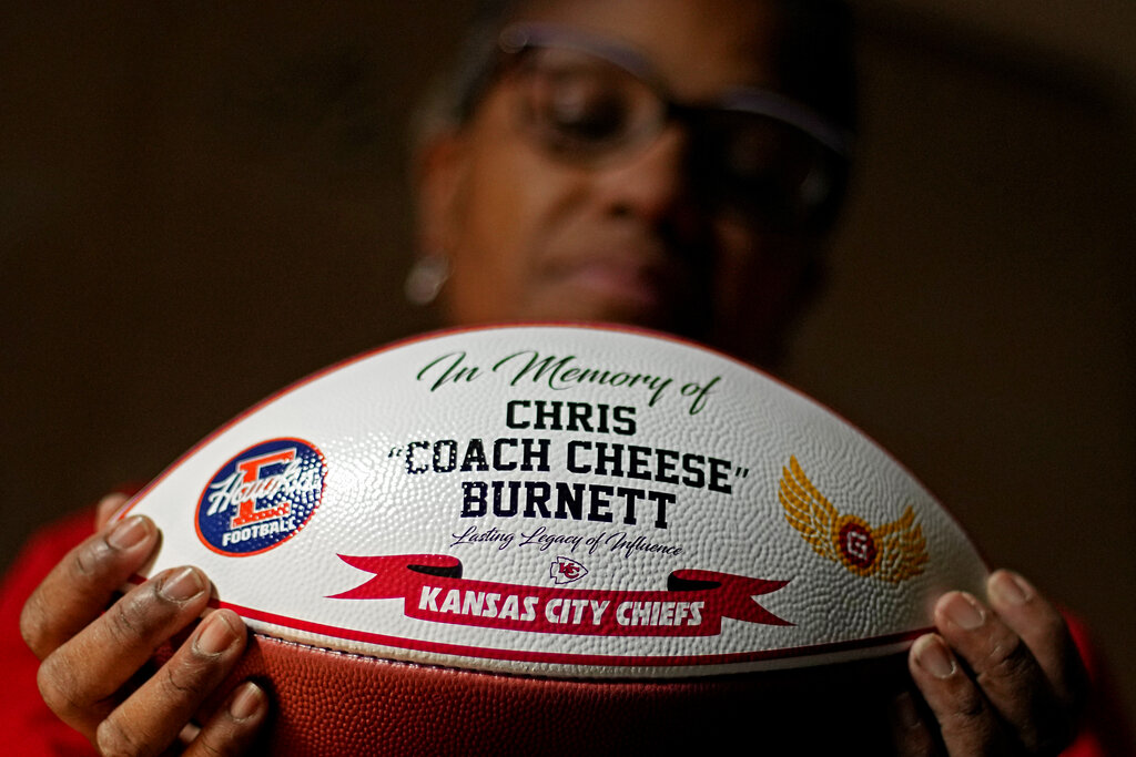 Carolyn Burnett holds a football presented as an award to her son by the Kansas City Chiefs, Monday...