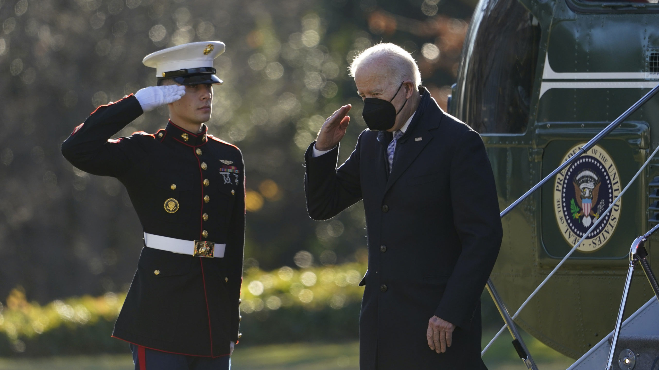 President Joe Biden salutes as he steps off Marine One on the South Lawn of the White House in Wash...