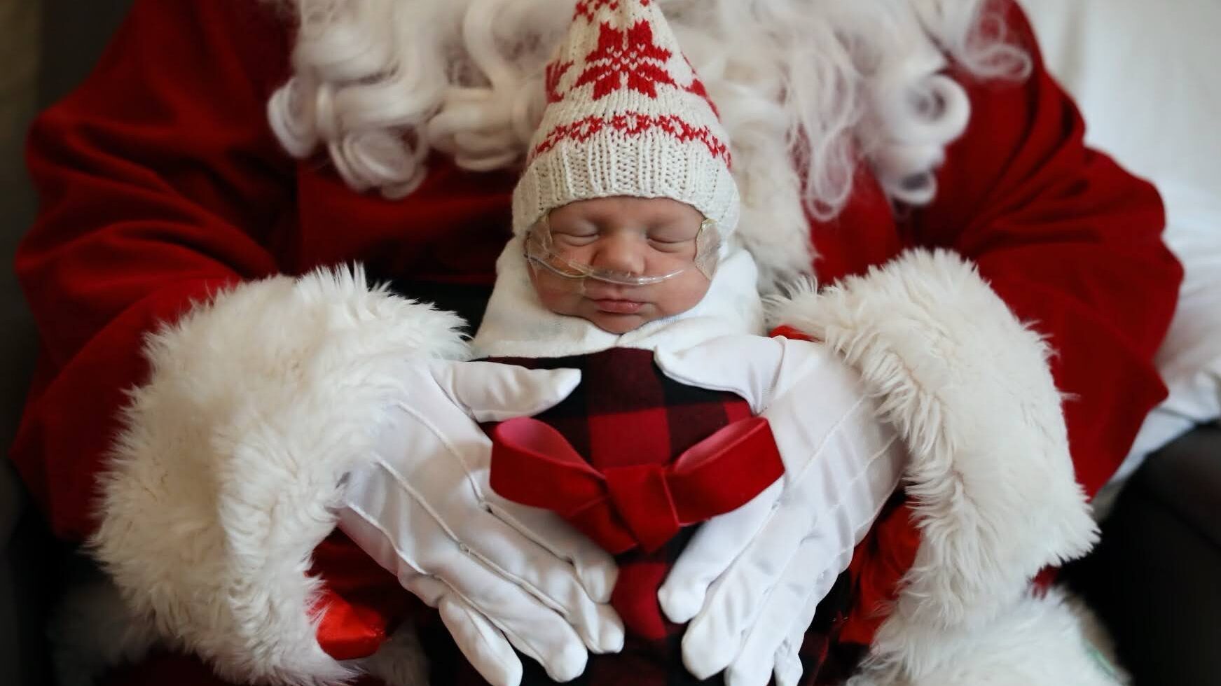 a baby is held by santa, baby pictures...