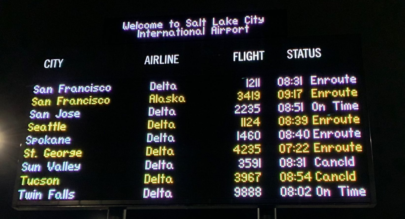 airport flight delays and cancellations at salt lake city displayed on electronic sign board...