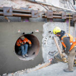 Crew members move large pipes through the seismic strengthening process of jack and bore under the existing footings of the Salt Lake Temple during the Temple Square renovation project, Salt Lake City, December 2021.