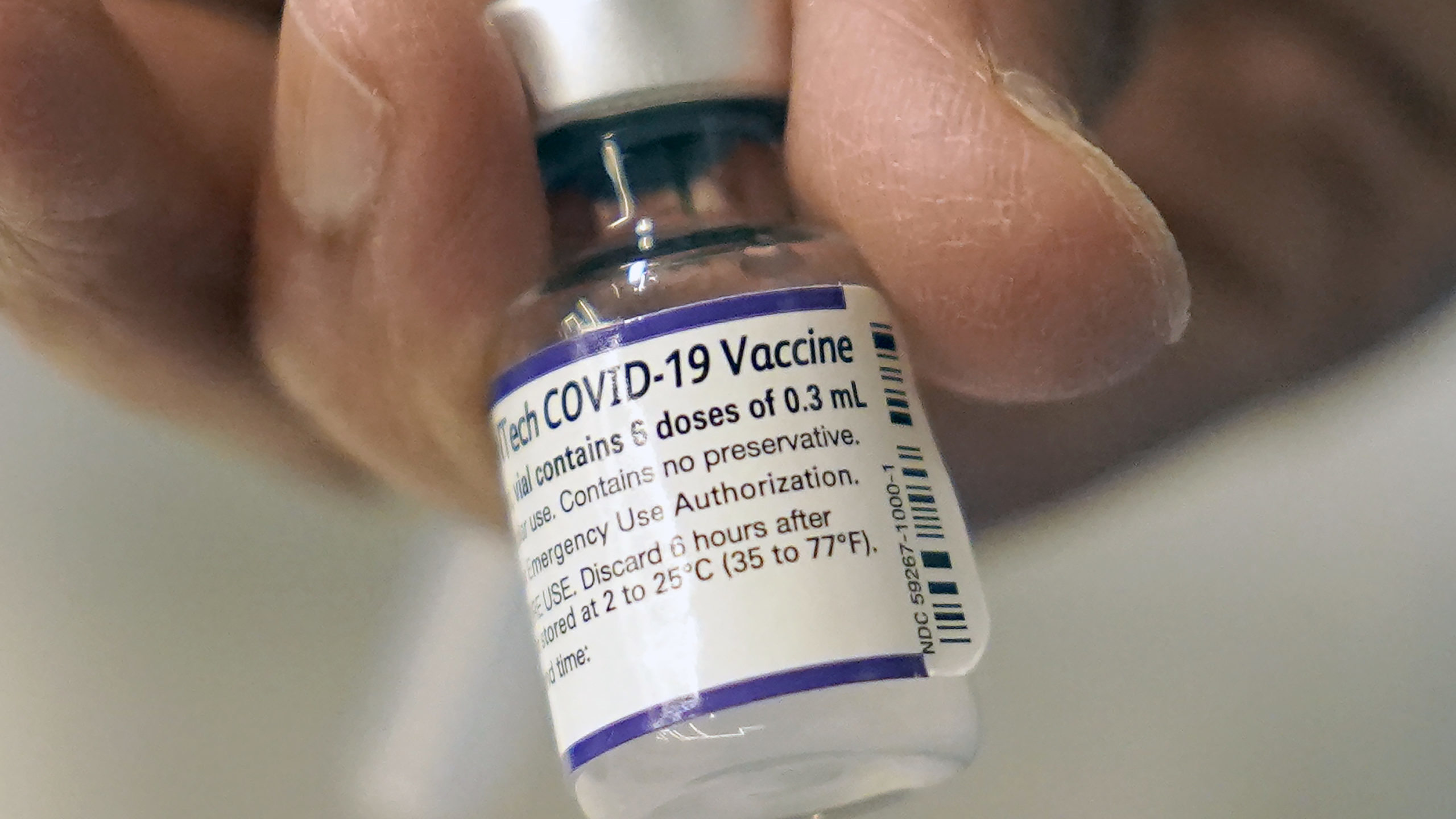 FILE - A doctor loads a dose of Pfizer COVID-19 vaccine into a syringe, Thursday, Dec. 2, 2021, at ...