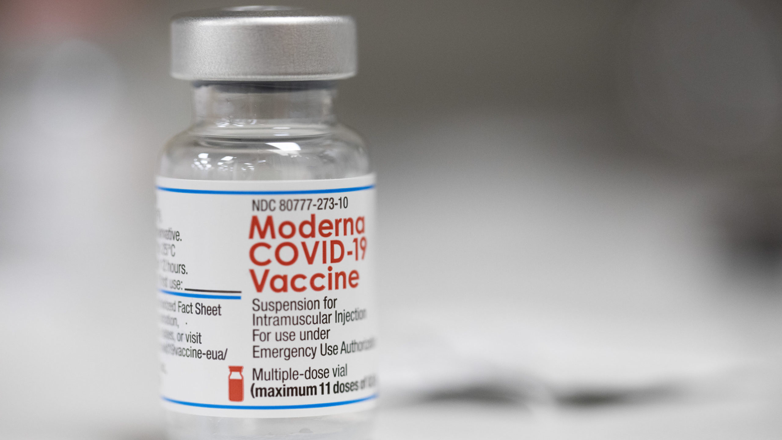 A vial of the Moderna COVID-19 vaccine is displayed on a counter at a pharmacy in Portland, Ore., M...
