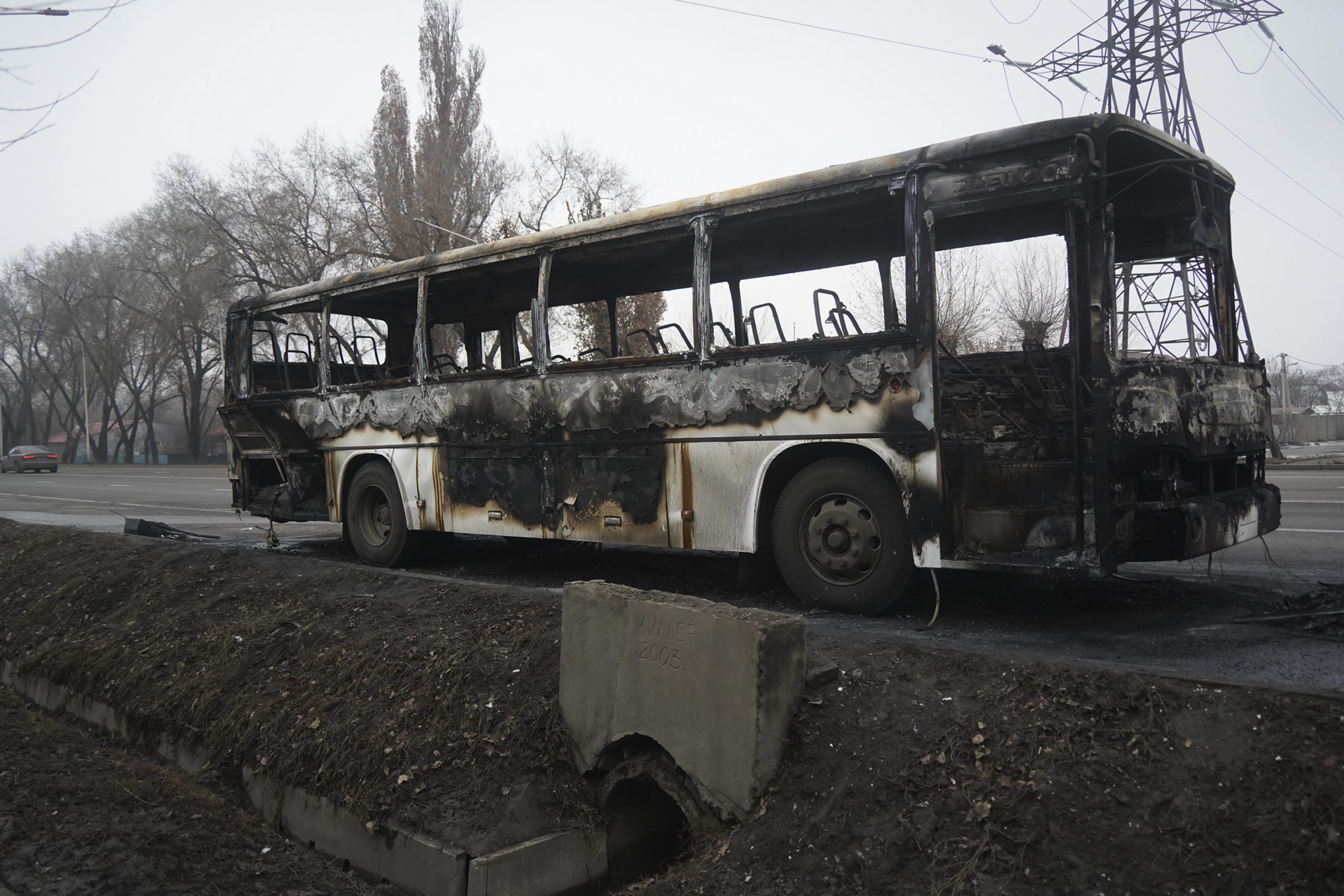 A bus, which was burned during clashes, is seen on a street in Almaty, Kazakhstan, Sunday, Jan. 9, ...
