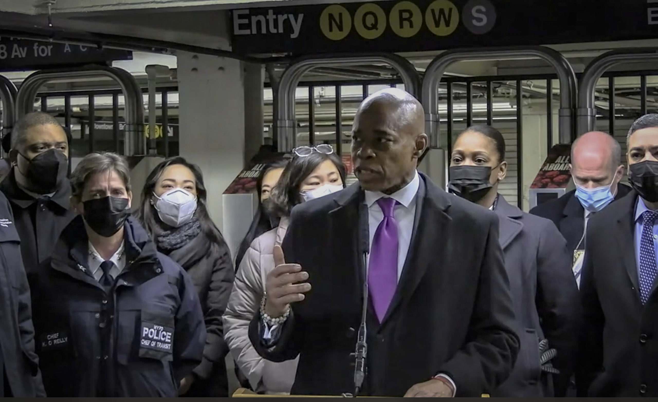 In this livestream frame grab from video provided by NYPD News, Mayor Eric Adams, foreground, with ...