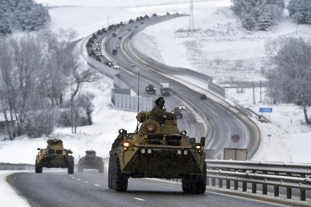 FILE - A convoy of Russian armored vehicles moves along a highway in Crimea, Tuesday, Jan. 18, 2022...