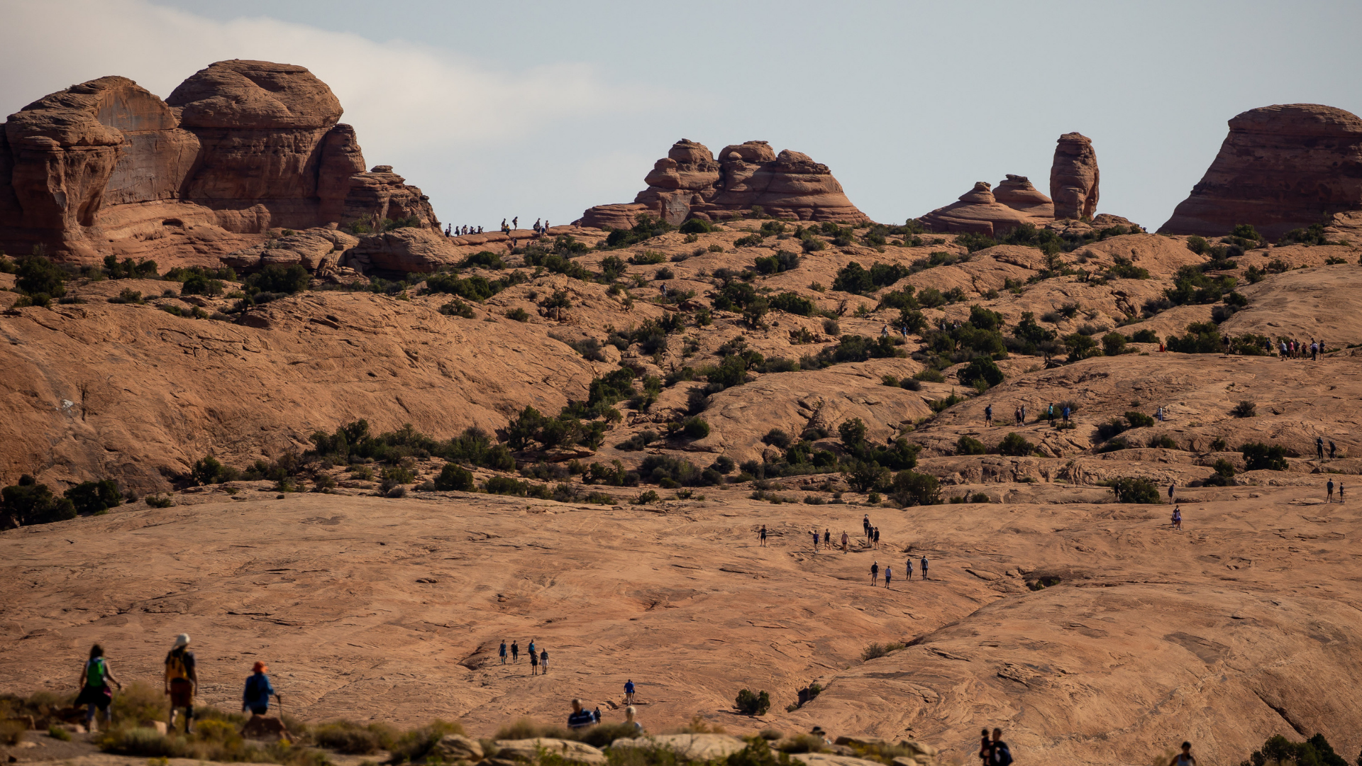 Visitors to Arches National Park make the hike to and from Delicate Arch, one of the park’s most ...