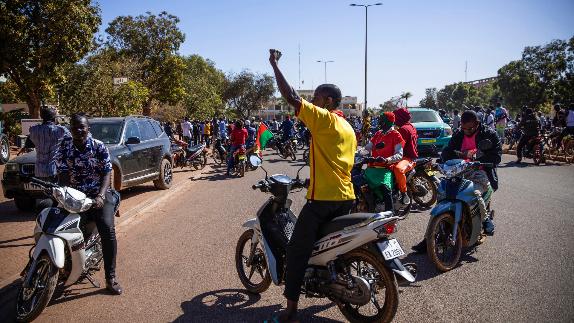 People cheer in support of putschist soldiers near the national television station in Ouagadougou, ...
