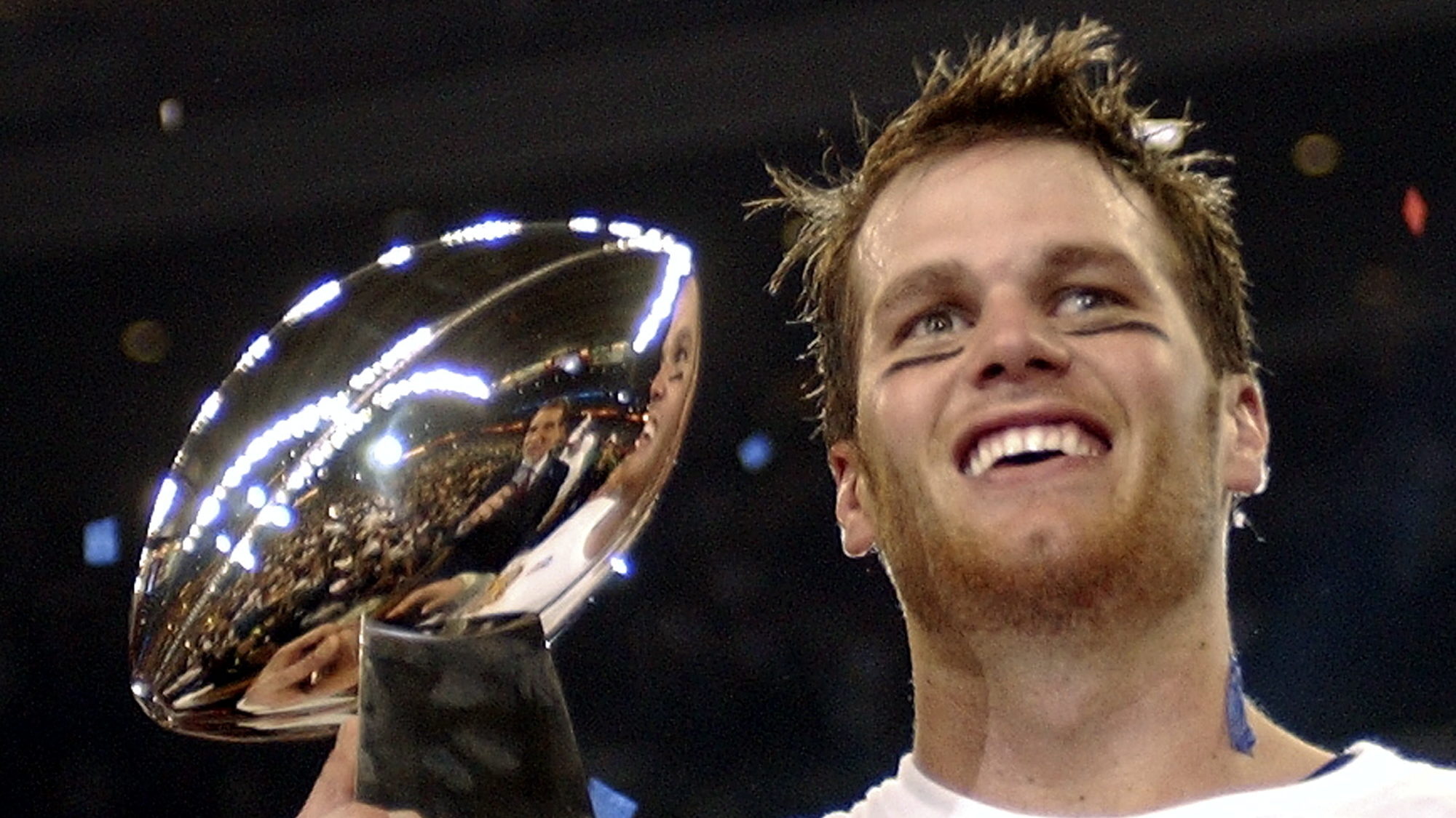 FILE - New England Patriots quarterback Tom Brady holds the Vince Lombardi Trophy after the Patriot...