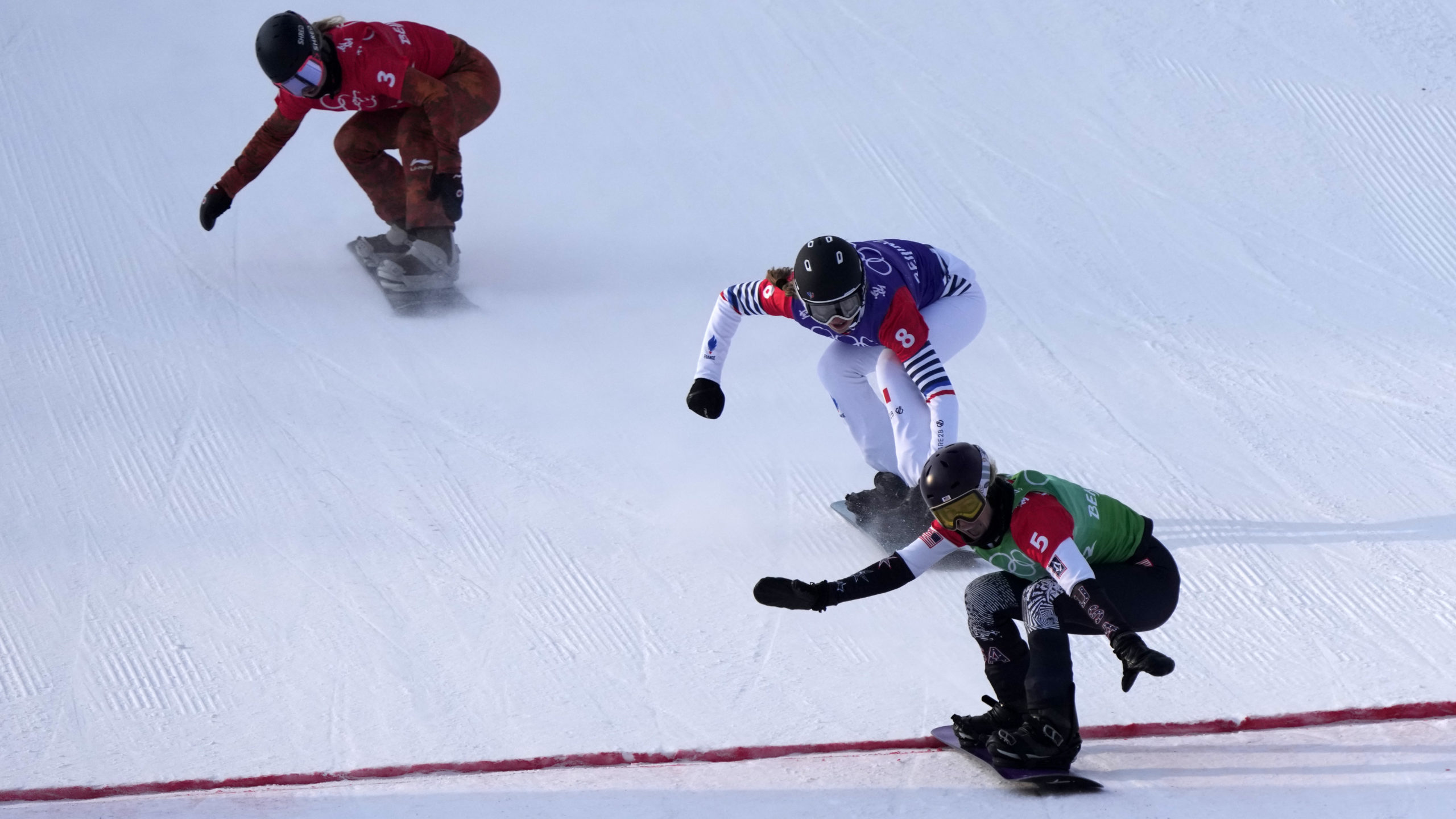 United States' Lindsey Jacobellis (5), followed by France's Chloe Trespeuch (8) and Canada's Meryet...