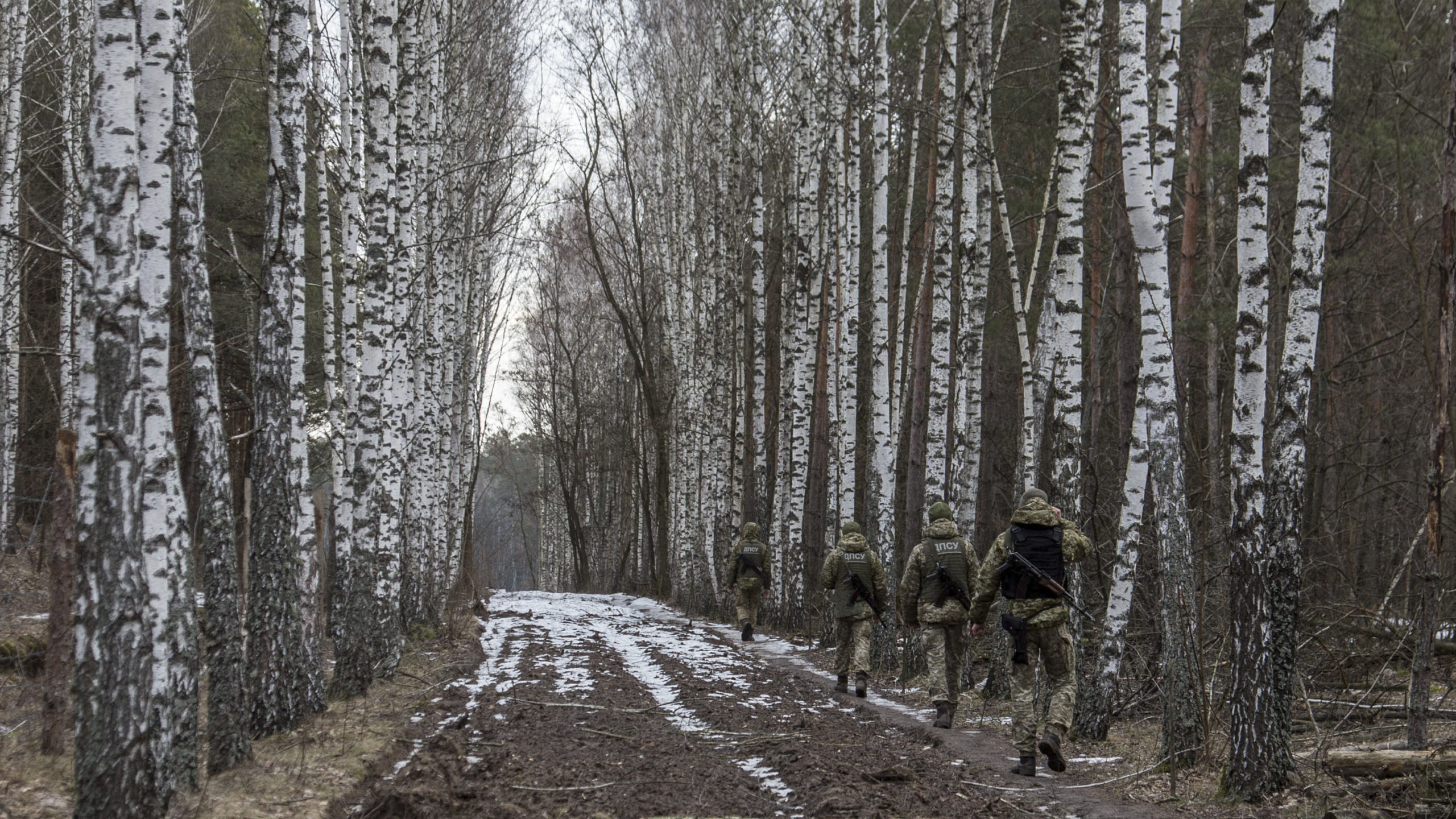 Ukrainian border guard officers patrol the Ukrainian-Belarusian state border at a checkpoint in Nov...