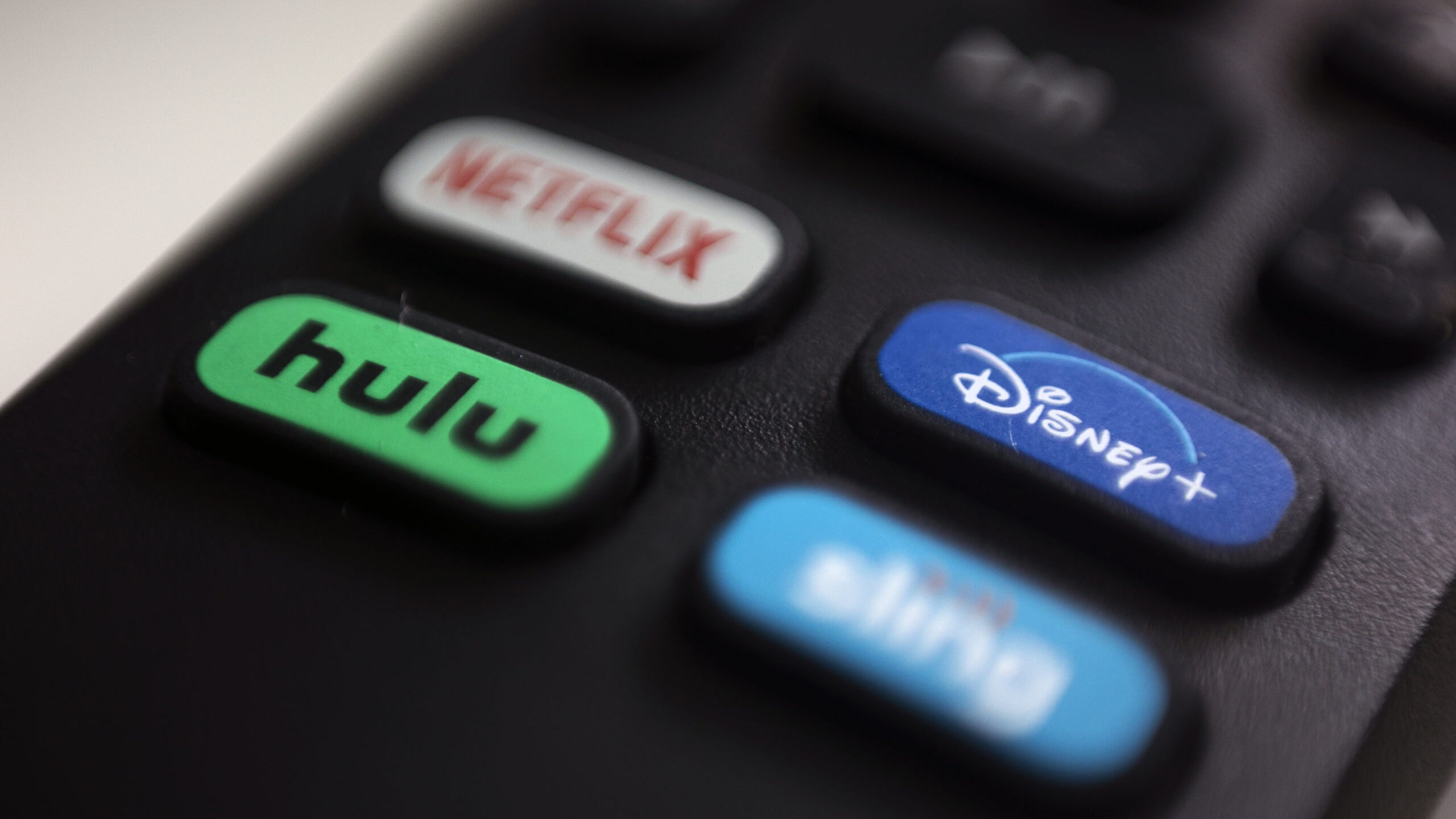 a remote with logos for netflix, hulu, disney and sling shown...