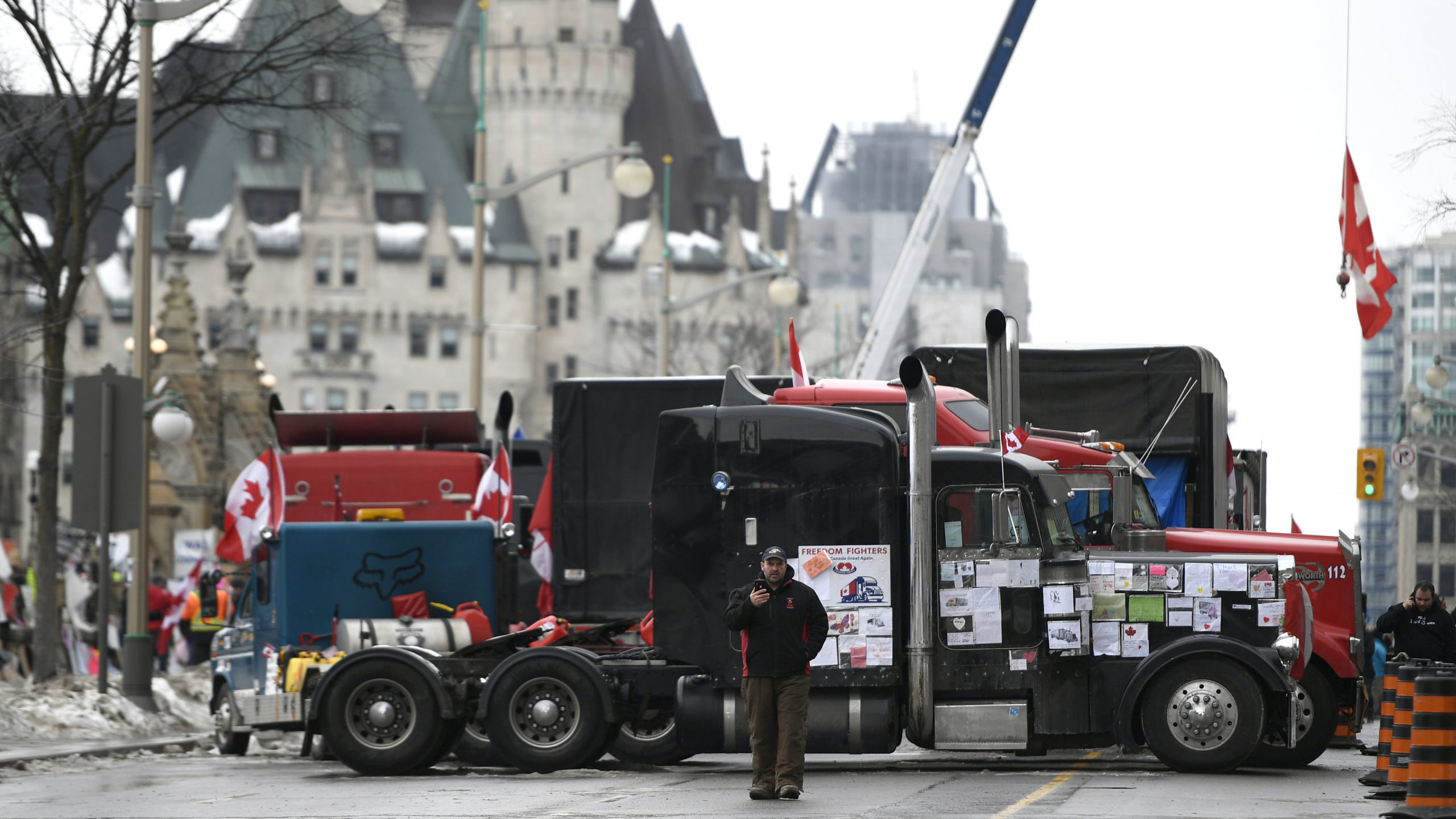 Trucks, are parked in front of the Chateau Laurier as a protest against COVID-19 restrictions conti...